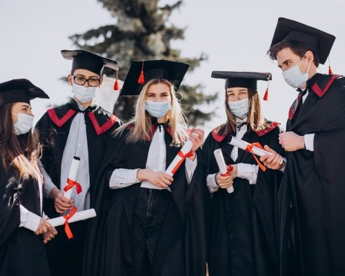 group-students-celebrating-graduation-together-wearing-face-masks_1303-27693